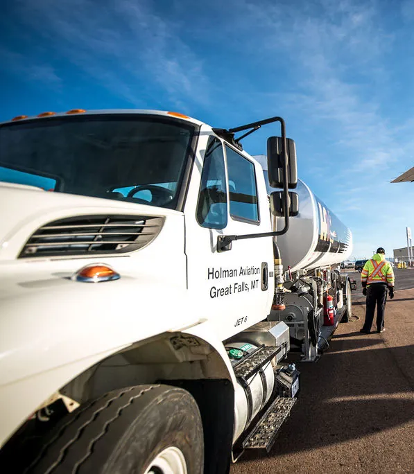 Close up of man in high vis jacket and Holman aviation truck