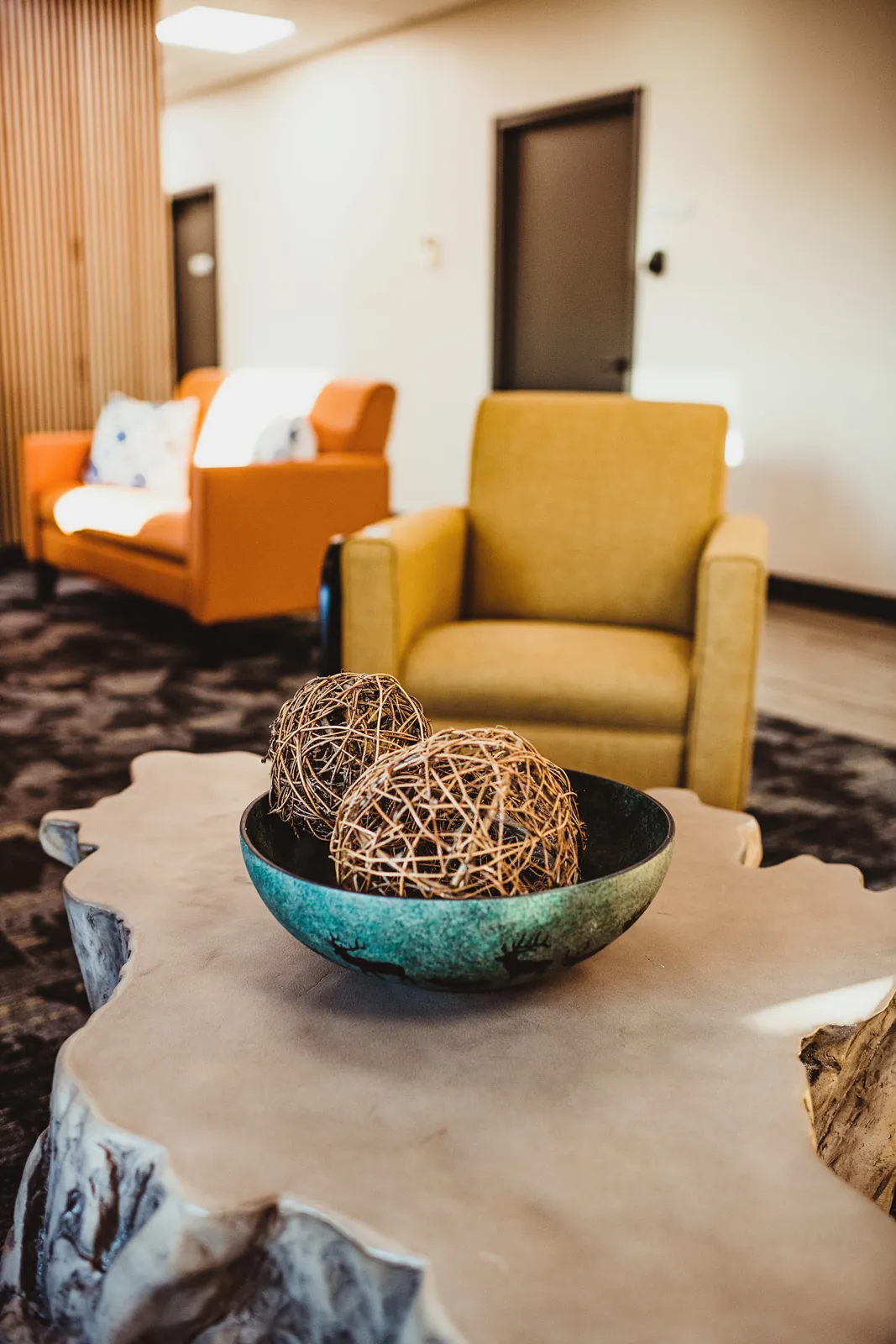 Lobby with view of coffee table, yellow chairs and decor